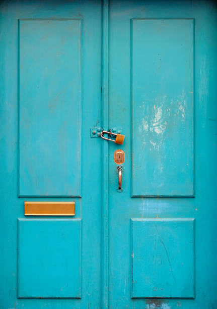 istock Turquoise wooden door with a padlock 1500839107