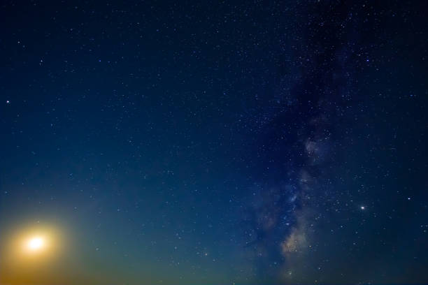 istock night starry sky with milky way and rising moon 1500842662