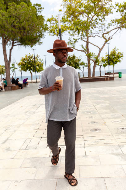 Portrait of men walking with coffee stock photo