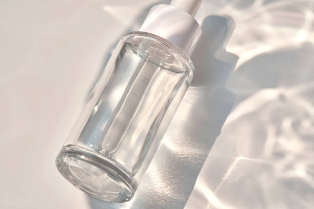 istock Serum bottle on a blue background with glare. 1500846293