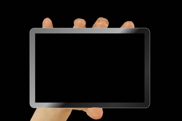 a tablet in a hand on the  black backgrounds