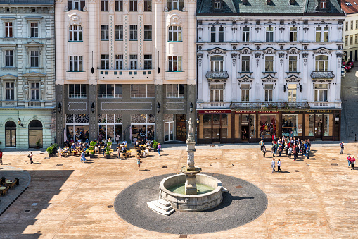 June 21, 2023: Bratislava, Slovakia - A city square in the Old Town of Bratislava. The photo was taken during a warm summer day and contains some people and local shops.