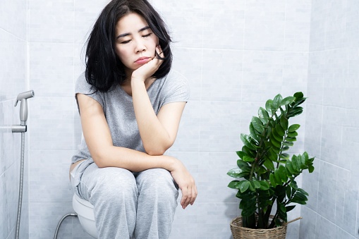 Asian woman have problems with   hypersomnia feeling sleepy all the time, chronic fatigue, sitting and sleeping in the restroom