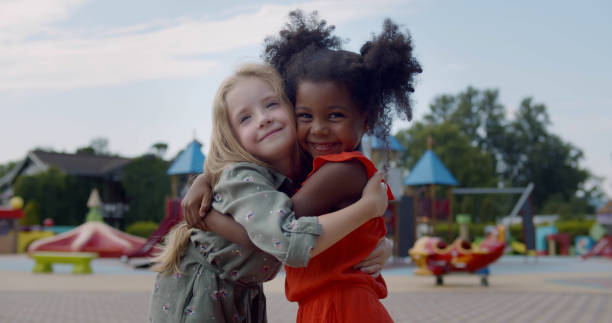 istock Diverse happy kids hugging on children playground 1500856298