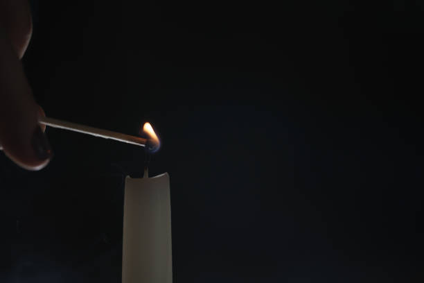 tall candle lighting in the dark environment, shallow focus