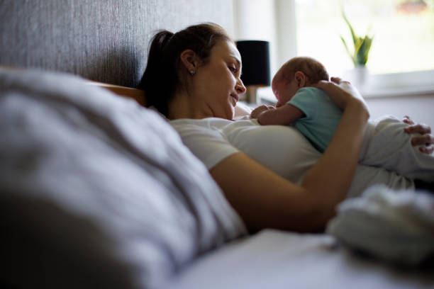 istock Mother playing with her baby in bed 1500858132