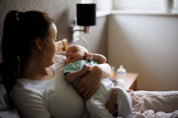 istock Mother playing with her baby in bed 1500858243
