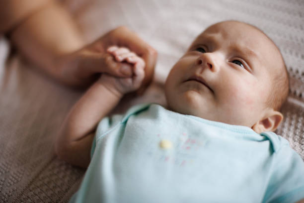 istock Newborn baby holding mother's hand 1500858323
