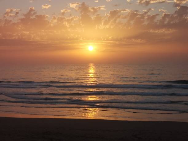 istock Sunset in agadir beach ,yellow sky and golden waves 1500862780