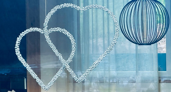 Double hearts hanging in a window