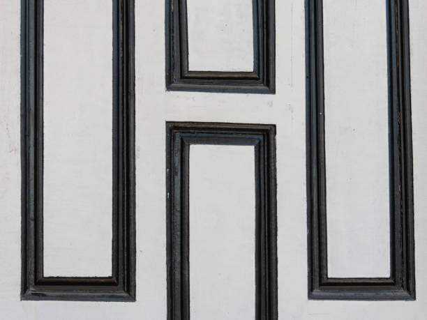 white wooden door with its elegant design featured striking black square pattern, adding touch of sophistication and modernity to the overall aesthetic.contrasting colors created visually captivating.