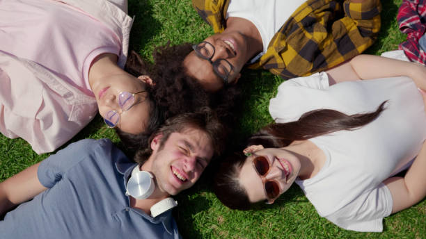 istock Top view of diverse students lying on grass and smiling 1500876582