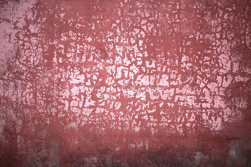 Grunge old cracked pink magenta red stone wall, full frame. Background and texture for design element.