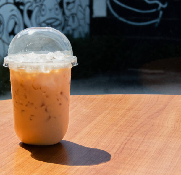 The Thai tea on the table is a delightful and refreshing beverage that captures the unique flavors of Thailand. Its vibrant orange color and creamy texture make it an irresistible treat. on Thai tea .