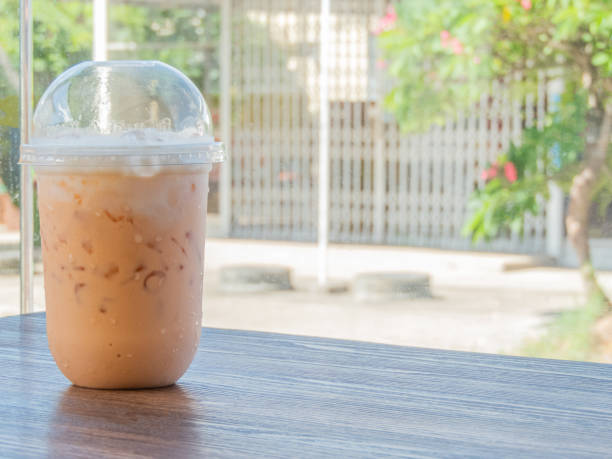 The Thai tea on the table is a delightful and refreshing beverage that captures the unique flavors of Thailand. Its vibrant orange color and creamy texture make it an irresistible treat. on Thai tea .