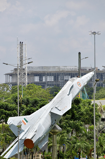 Kolkata / Calcutta, West Bengal, India: Indian Air Force MiG-27 on static display - Mikoyan-Gurevich MiG-27 ('Микоян-Гуревич МиГ-27 ', NATO codename Flogger-D ) is a single-engine, variable geometry wing aircraft developed in the Soviet Union during the Cold War. It is an advanced fighter-bomber variant of the MiG-23 - From 1986 India built a model called Bahadur / 'Valiant' (modernized MiG-27M) under license. high altitude conflict in Kargil in 1999 - many planes were lost to accidents - Netaji Subhash Chandra Bose International Airport / Kolkata International Airport.