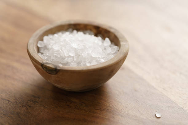 istock coarse sea salt in wooden bowl on table 1500881000