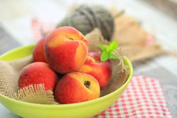 yellow peach fruit on a table, nectarine