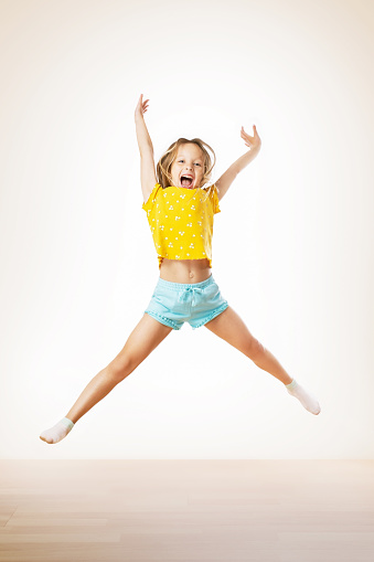 Happy little girl jumping. Childhood children lifestyle concept.