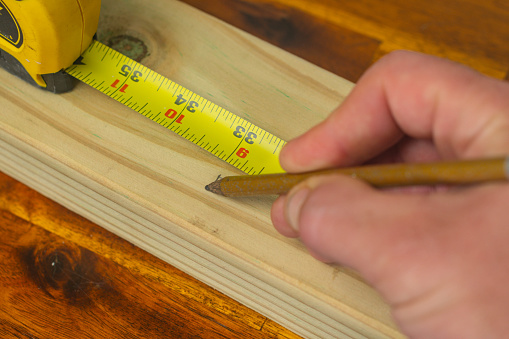 DIY tools. These are well used screwdrivers, paintbrushes and craft knives on a wooden floor.