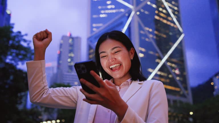 Investment success, Asian woman successfully investing in the stock market, expressing joy.