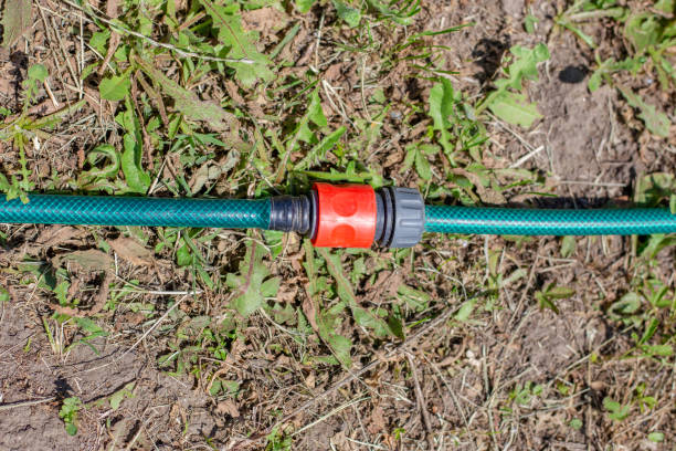 Quick coupling on a garden hose for watering lying on the ground.
