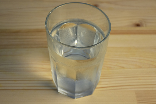 Cold drink water in a drinking glass on the wood table