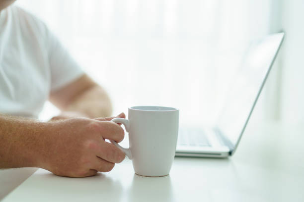 istock Man checking an email on laptop in morning. 1500891193