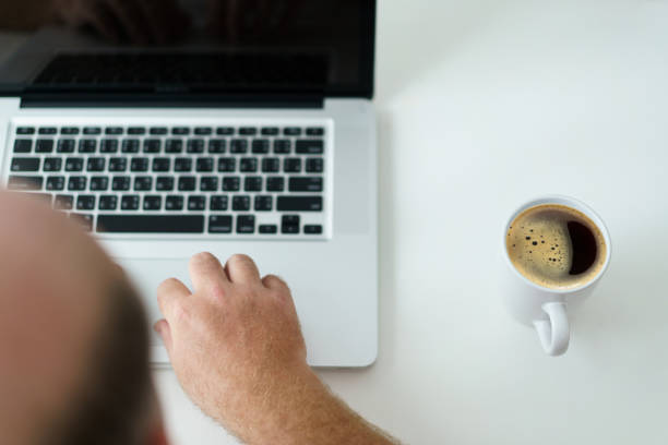 istock Man checking an email on laptop in morning. 1500891290