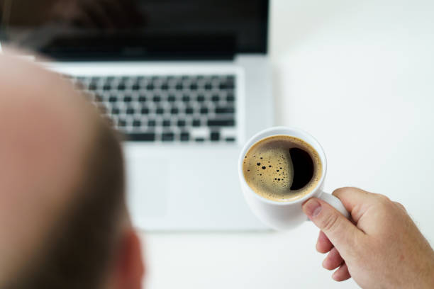 istock Man checking an email on laptop in morning. 1500891297