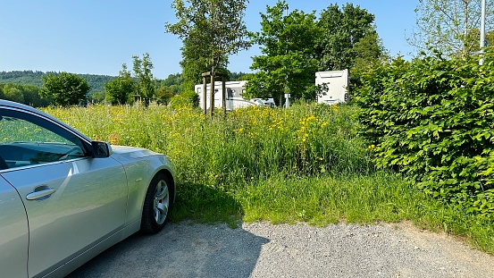 Winnenden, Germany - May 27th - 2023: RV parking area nearby a public swimming pool.