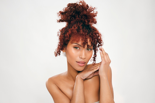 Beauty portrait of mixed race girl with afro hair. Cosmetics, makeup, and fashion