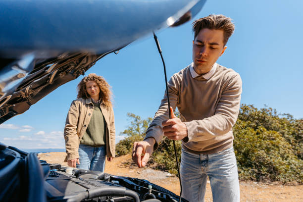 istock Young Man Looking Under The Hood Of A Broken Car 1500894845