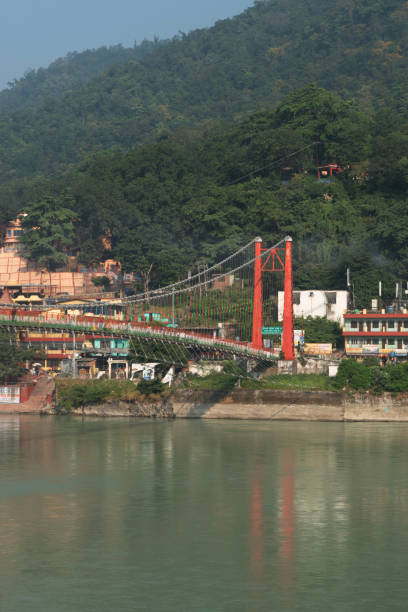 istock Vertical view of rishikesh ram jhula bridge with mountains and ganga river 1500897078
