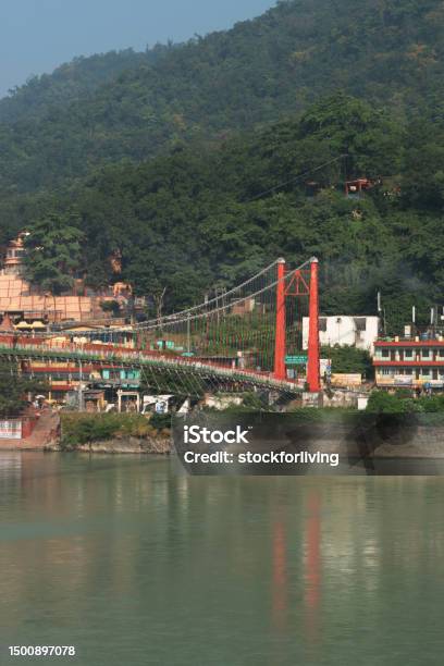 Vertical View Of Rishikesh Ram Jhula Bridge With Mountains And Ganga River Stock Photo - Download Image Now