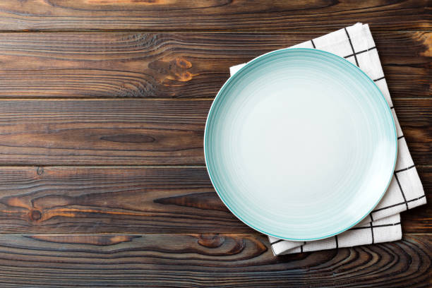 istock Top view on colored background empty round blue plate on tablecloth for food. Empty dish on napkin with space for your design 1500897147