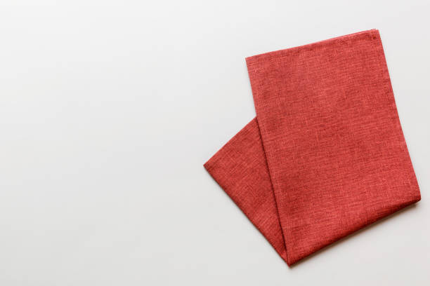 istock top view with red empty kitchen napkin isolated on table background. Folded cloth for mockup with copy space, Flat lay. Minimal style 1500897186