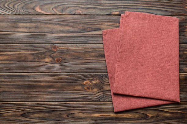 istock top view with red empty kitchen napkin isolated on table background. Folded cloth for mockup with copy space, Flat lay. Minimal style 1500897205