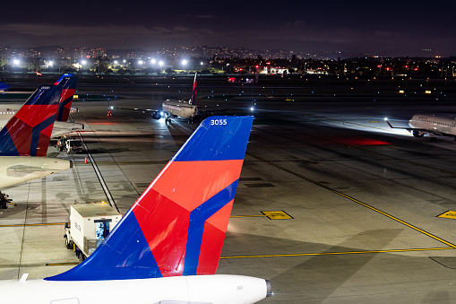 Los Angeles, CA, USA - February 11, 2023:  Evening image of Delta Air Lines airplanes at gates at Los Angeles International Airport, LAX
