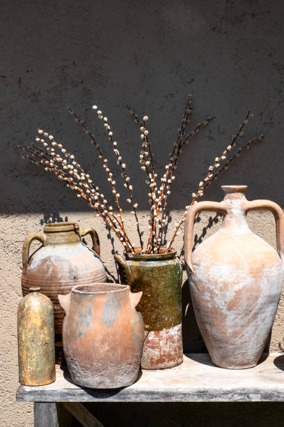 Flowers In Rustic Pots Near Dark Grey Wall, Modern Design stock photo