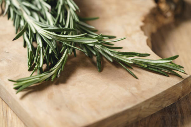 istock fresh rosemary bunch on wood table 1500901364