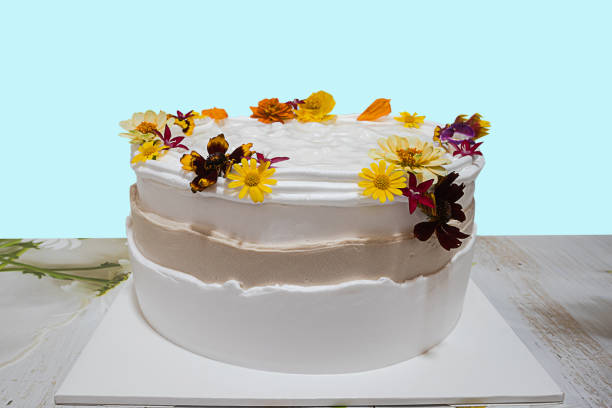istock Delicious coconut cakes decorated with various flowers placed on a wooden table. blue background 1500902071