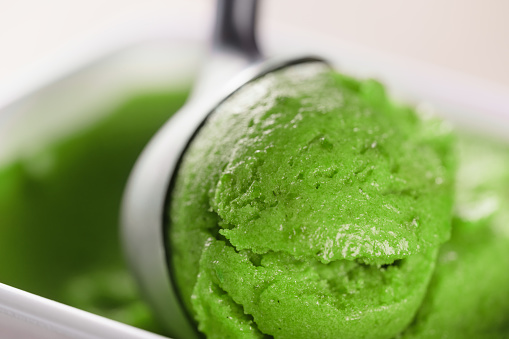 scooping green ice cream close up shot shallow focus