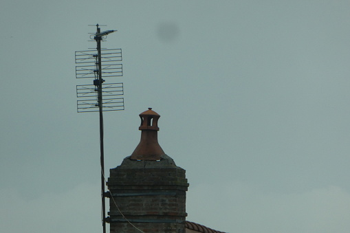 photo taken from a rake antenna on the roof partial view of the roof. Rake antennas are increasingly replaced by parabolic antennas