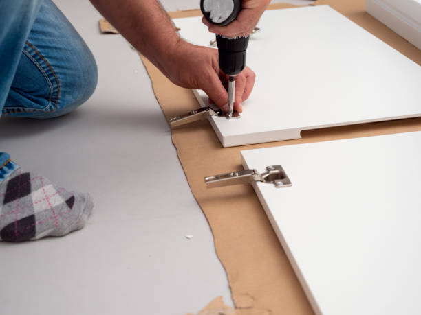 istock A man assembles furniture at home with a professional screwdriver. 1500908906