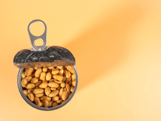 istock Roasted peanuts in an open jar on orange. 1500909266
