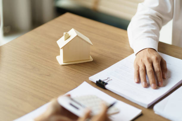 istock Sales manager giving advice application form document, considering mortgage loan offer for car and house insurance. Real estate investment Property insurance and security. Real estate agent offer house. 1500909356