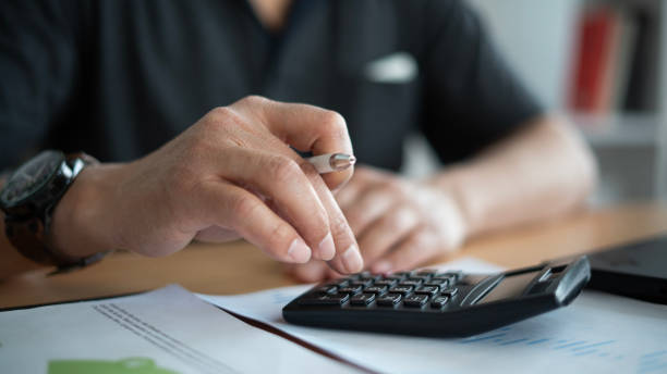 Free Stock Photo of Person Using Calculator on Sheet of Paper ...