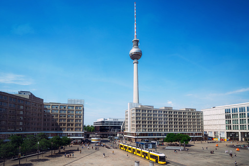 yellow cable car crossing berlin Alexanderplatz