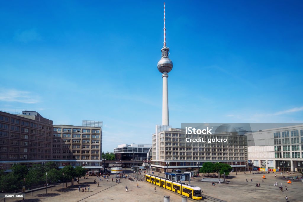 Berlin Alexanderplatz at blue sunny day yellow cable car crossing berlin Alexanderplatz Alexanderplatz Stock Photo
